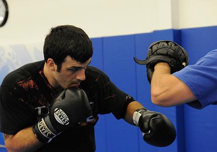 Rolles works on his striking with Mark Henry