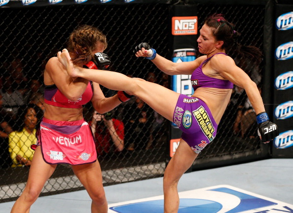 (R-L) Cat Zingano kicks Miesha Tate in their bantamweight fight at the Mandalay Bay Events Center  on April 13, 2013 in Las Vegas, Nevada.  (Photo by Josh Hedges/Zuffa LLC/Zuffa LLC via Getty Images)