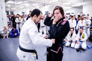 Dominyka receiving her black belt. Photo: John "Ric" Ricard