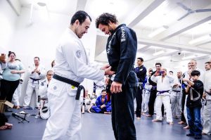 Marcos receiving his black belt. Photo: John "Ric" Ricard